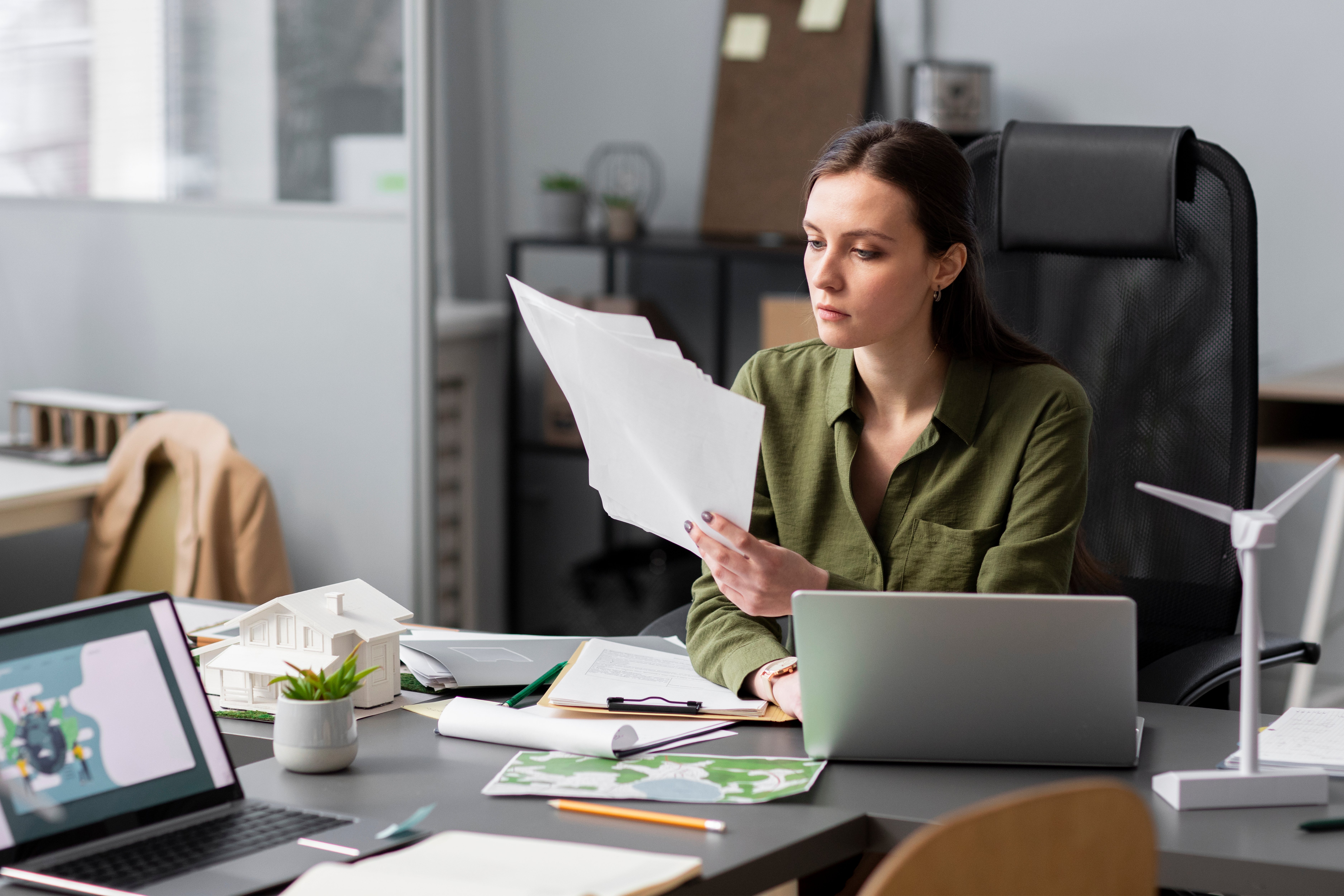 Business professional reviewing a Statement of Work agreement in the office to ensure clear staffing requirements.